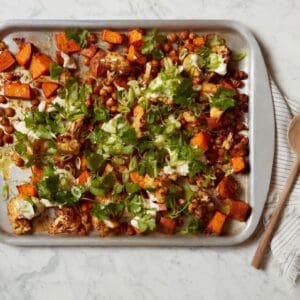 Harissa Sweet Potato Bowl and chickpeas on a baking sheet.