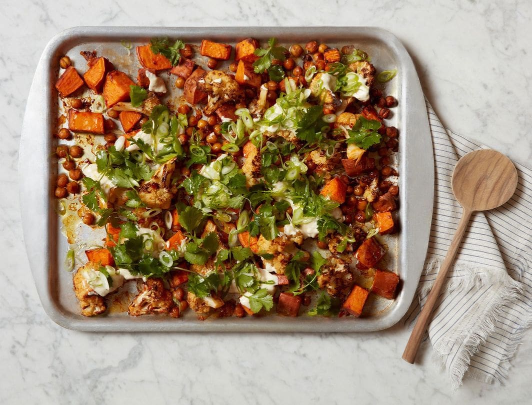 Harissa Sweet Potato Bowl and chickpeas on a baking sheet.