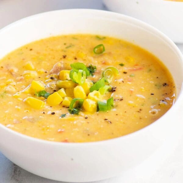 Two bowls of Sweet Corn Chowder with green onions.