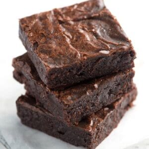 Three Decadent Chocolate Brownies stacked on top of each other.