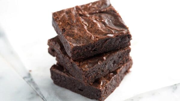 Three Decadent Chocolate Brownies stacked on top of each other.