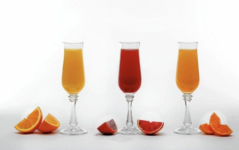 Three Mimosa Kits with orange slices in them.