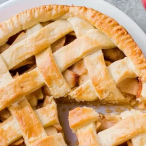 Fresh apple pie on a white plate.