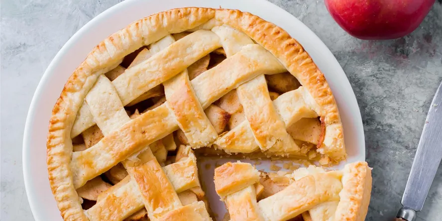 Fresh apple pie on a white plate.